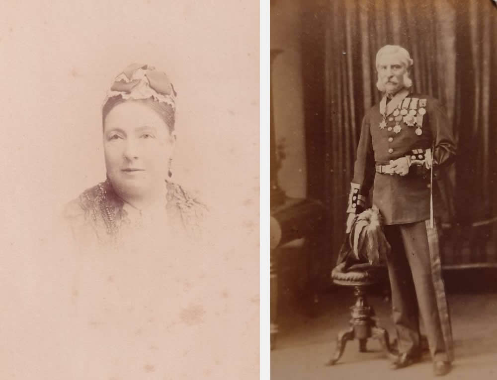 Two sepia-coloured photographs, featuring, to the left, a head and shoulders image of Martha Power (née Moorhead), the only daughter of John and Susan Moorhead of Annaghmakerrig House. The date of the image is unknown. Martha is wearing a decorative head cap, long earrings, a decorative dress and a necklace. To the right, Martha’s husband, William James Tyrone Power, is shown full length, in full British army uniform, with medals on his chest and around his neck, and his ceremonial feathered hat held in his right hand. William is white haired, with white sideburns and a large white moustache. He stands beside a decorate knee high wooden stool to his right.